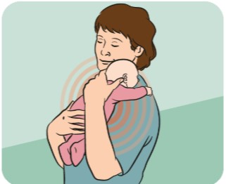 Mother holding her baby in her shoulder. 