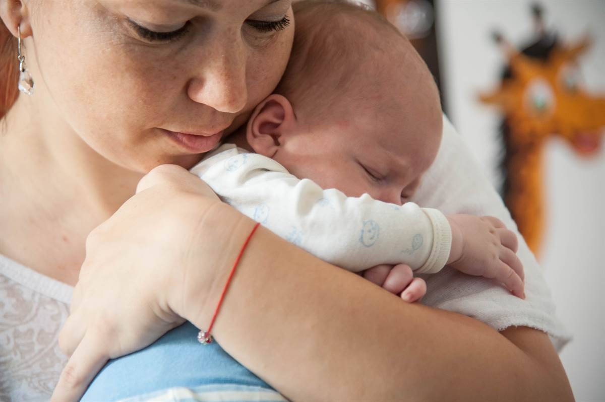  A mother holding a baby in her hands 