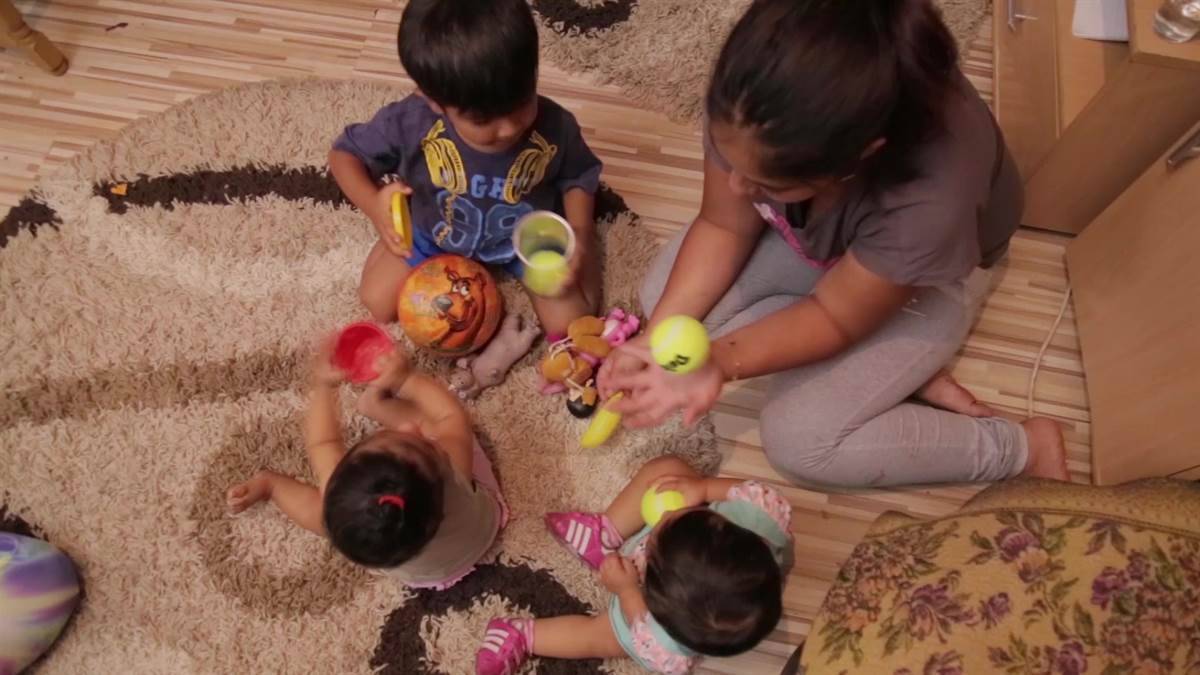 Children playing all together on the carpet 
