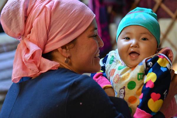 Mother and her baby girl (1 y.o) smiling