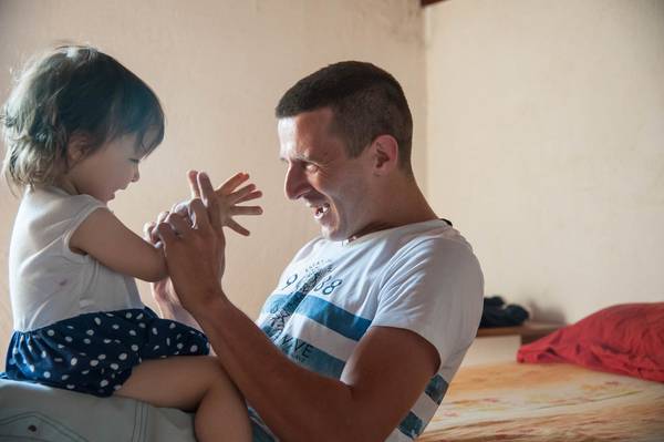 Father singing with his toddler daughter.