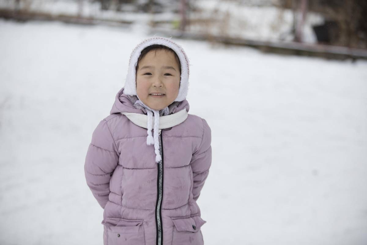 Girl paying in the snow.