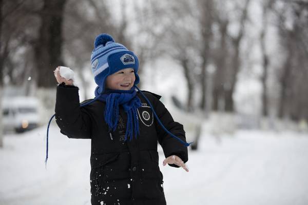 Boy playing in the snow.