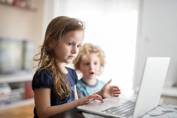 Milica 6 years old, and Petar 4 years old, are photographed in front of a laptop, in the city of Podgorica, Montenegro, as part of the promotion of the “End Violence Online” campaign.