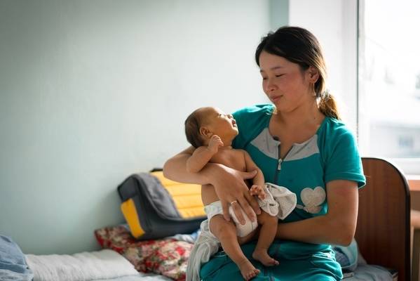 Boy (1.5 months) in his mothers arms at a hospital in Kyrgyzstan.