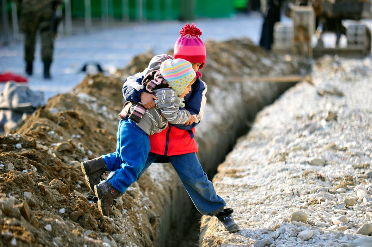 Siblings helping each other.