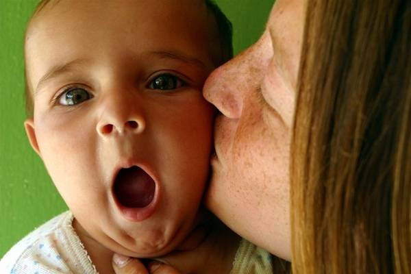 Mother with her baby giving him positive attention.
