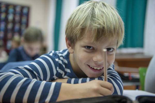 Boy attending classes at inclusive primary school