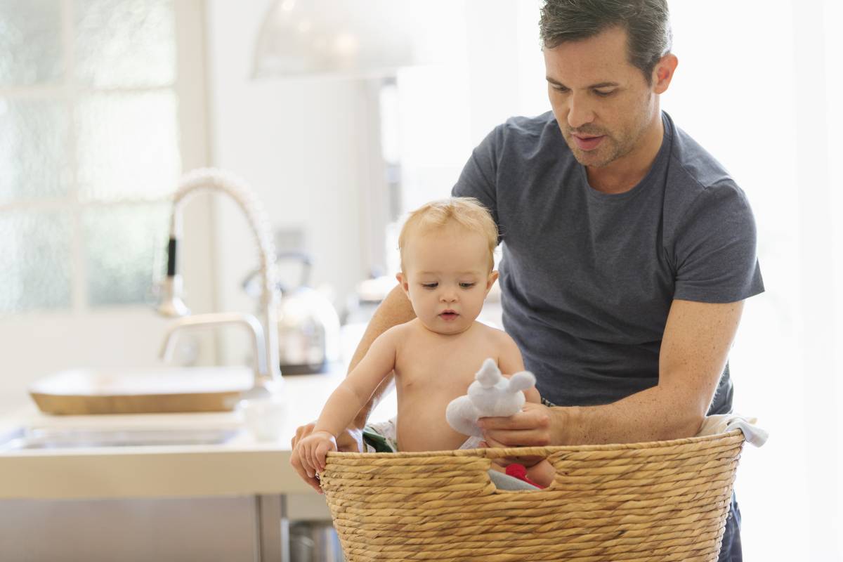 A father is showing a toy to his baby