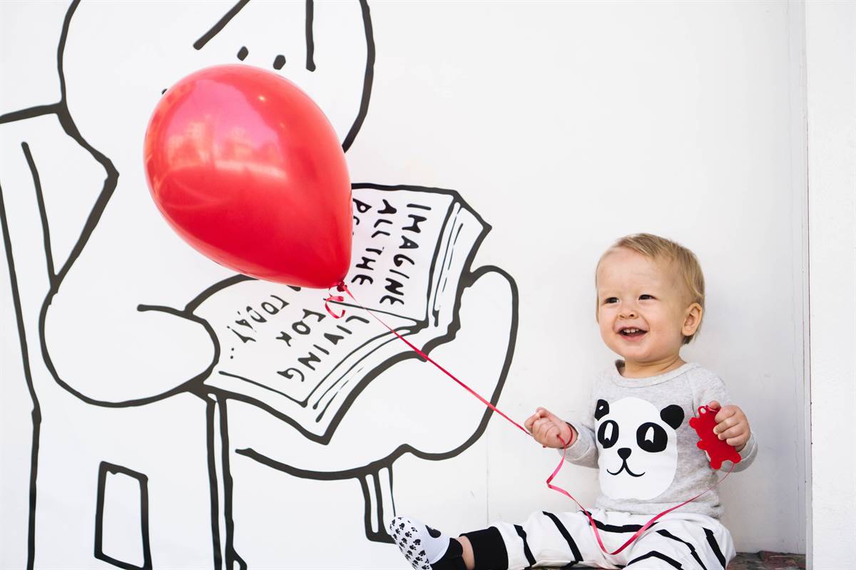 Baby with a red balloon