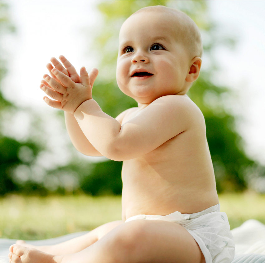 Smiling baby is clapping