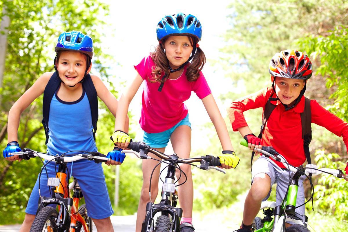 Children on bicycles with protective helmets