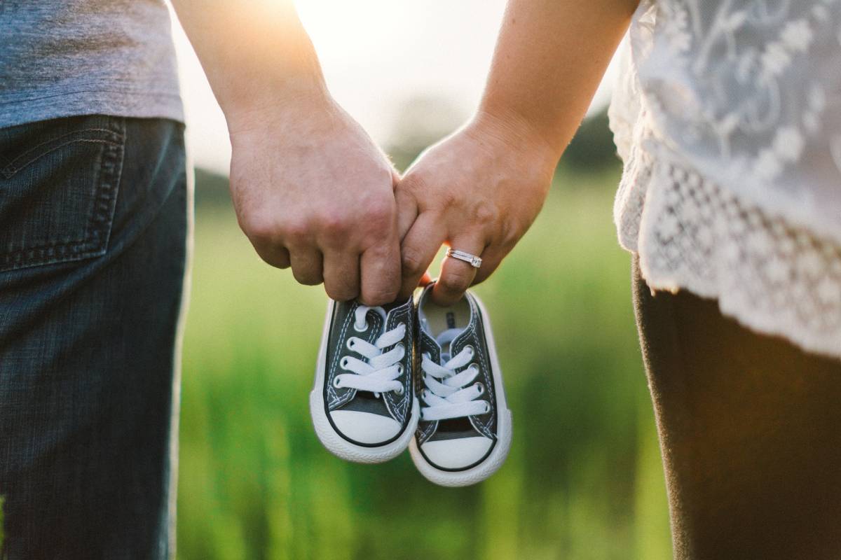 Mother father holding hands