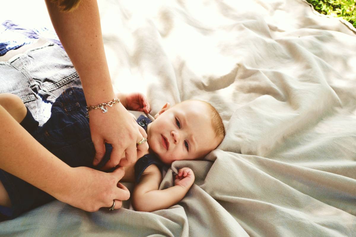 A parent is changing the baby