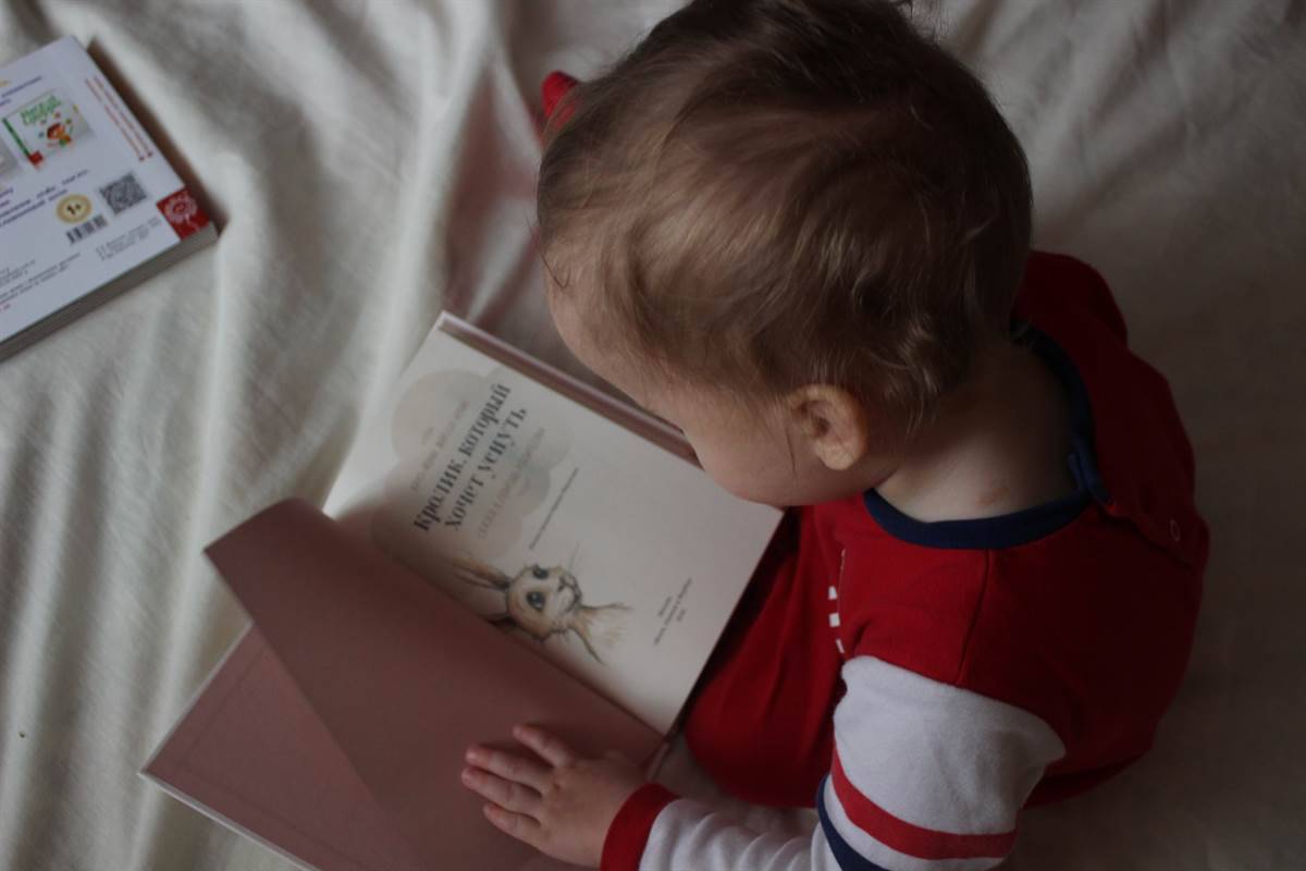 toddler playing at home reading