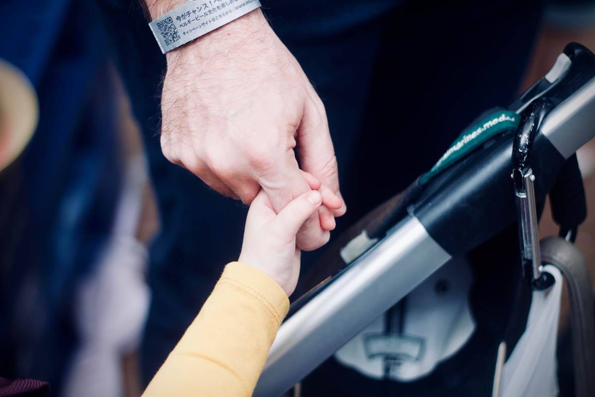 Father with daughter holding hands