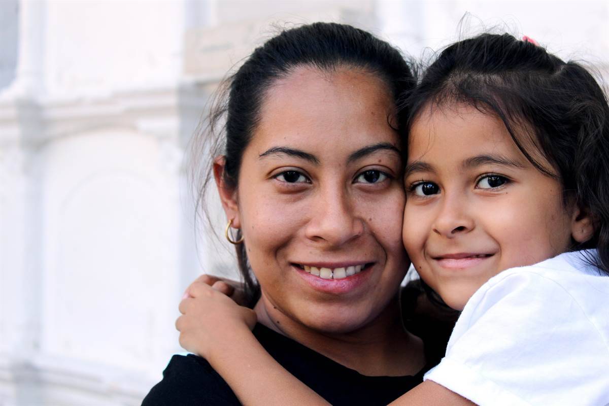 Mother holds her daughter