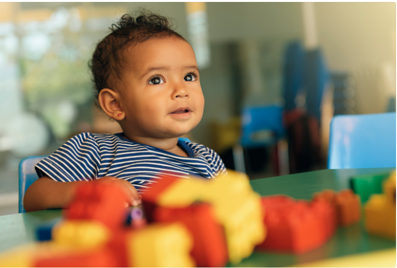 A child surrounded by colourful cubes