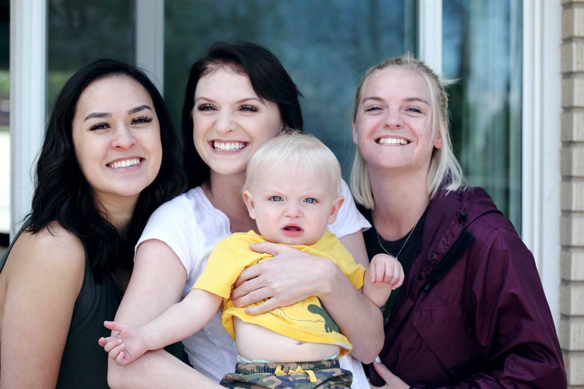 educator holds mother's daughter