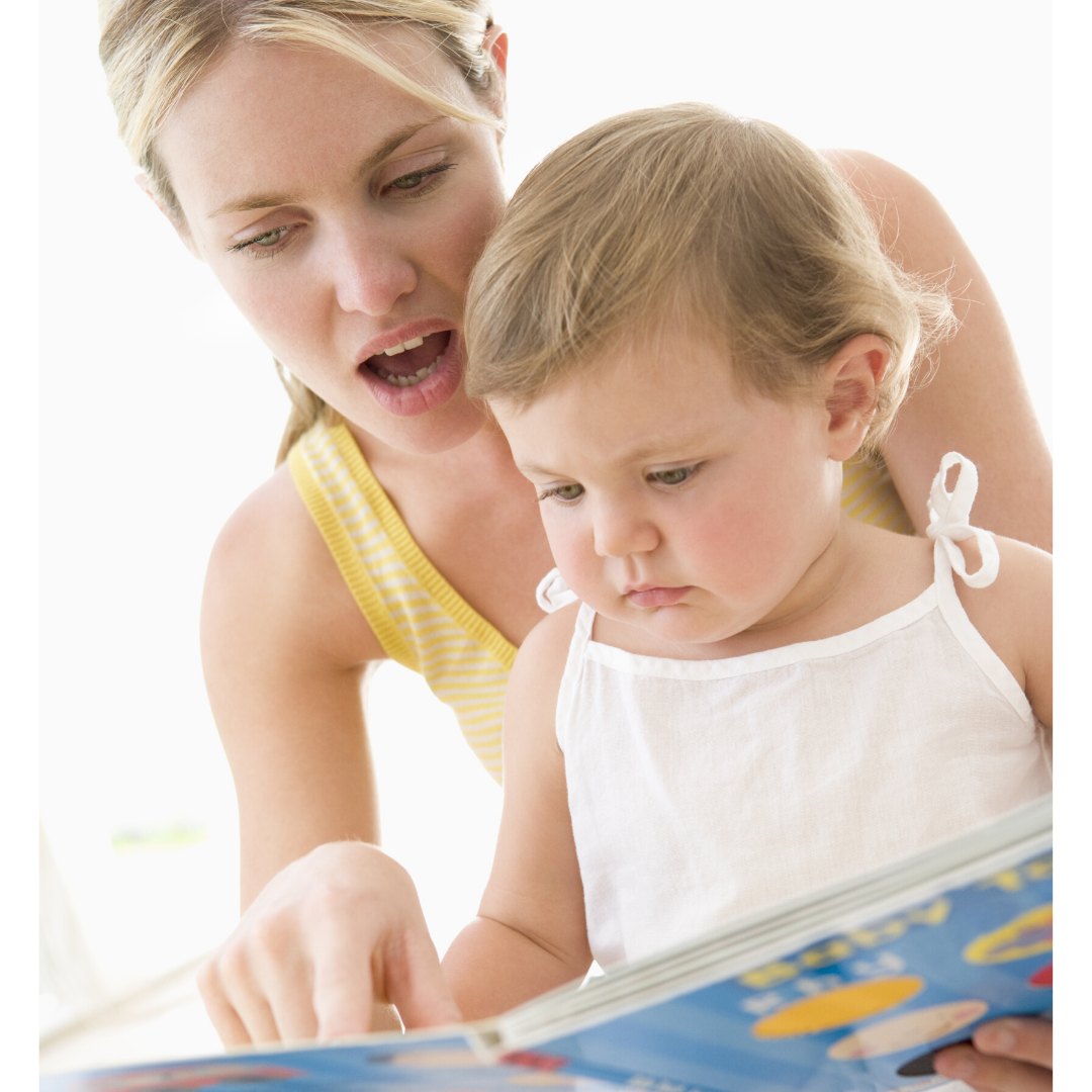 A mother and her child are looking the images at the book together