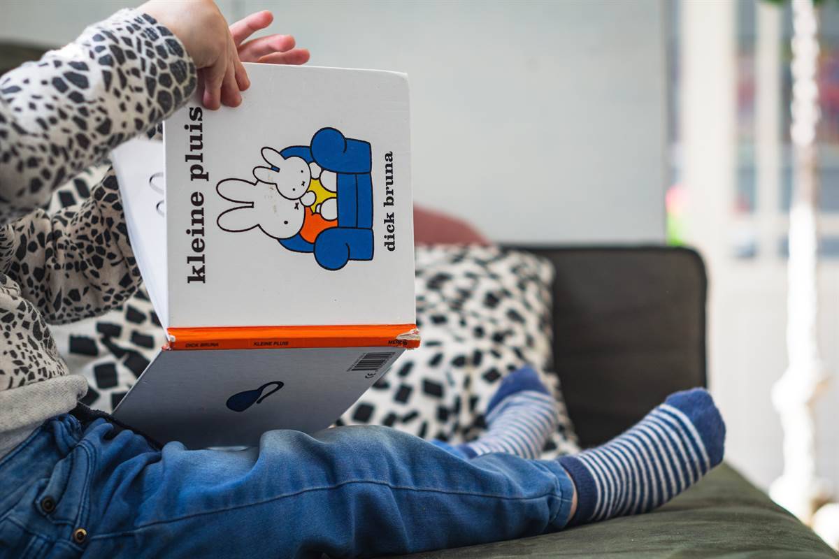toddler playing at home reading