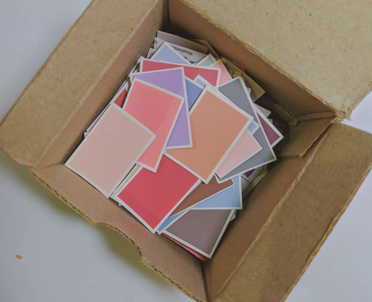 A carboard box with coloured papers inside