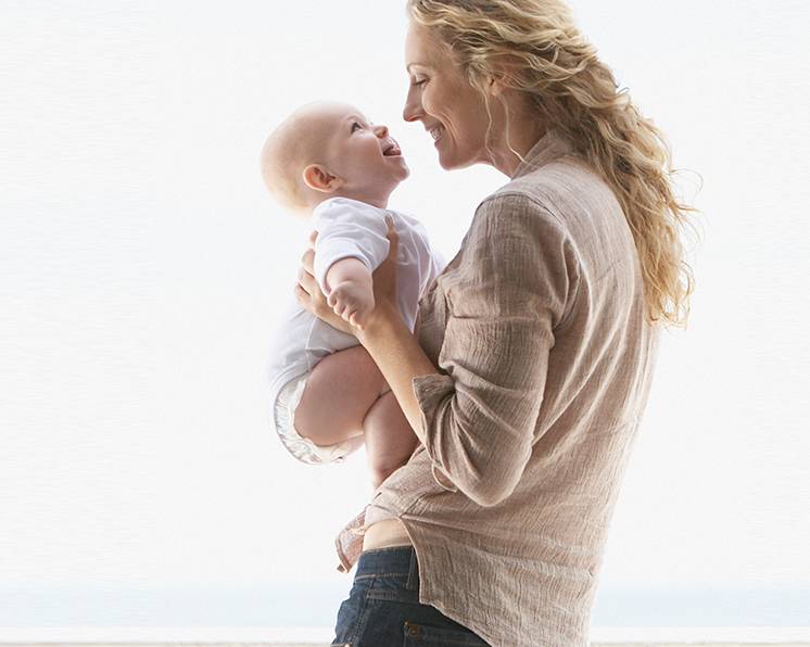 A mother and a child smiling at each other
