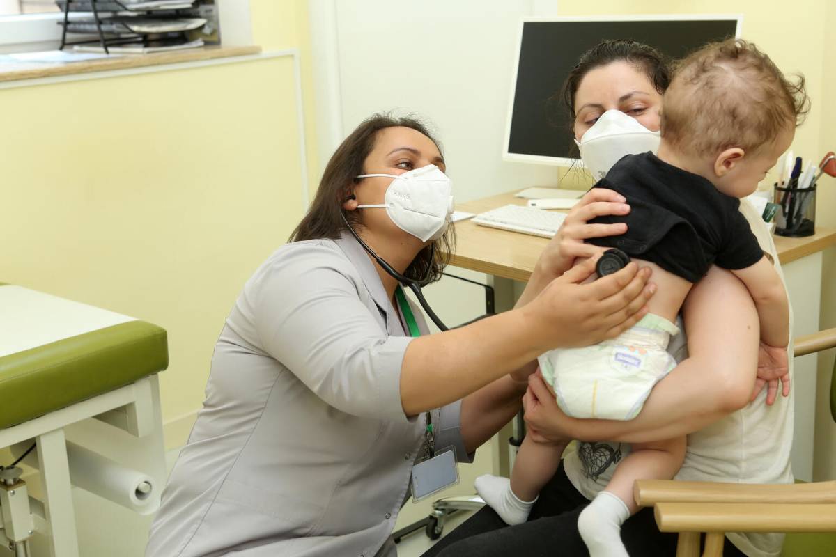 Mother with 5 month old son at their medical checkup