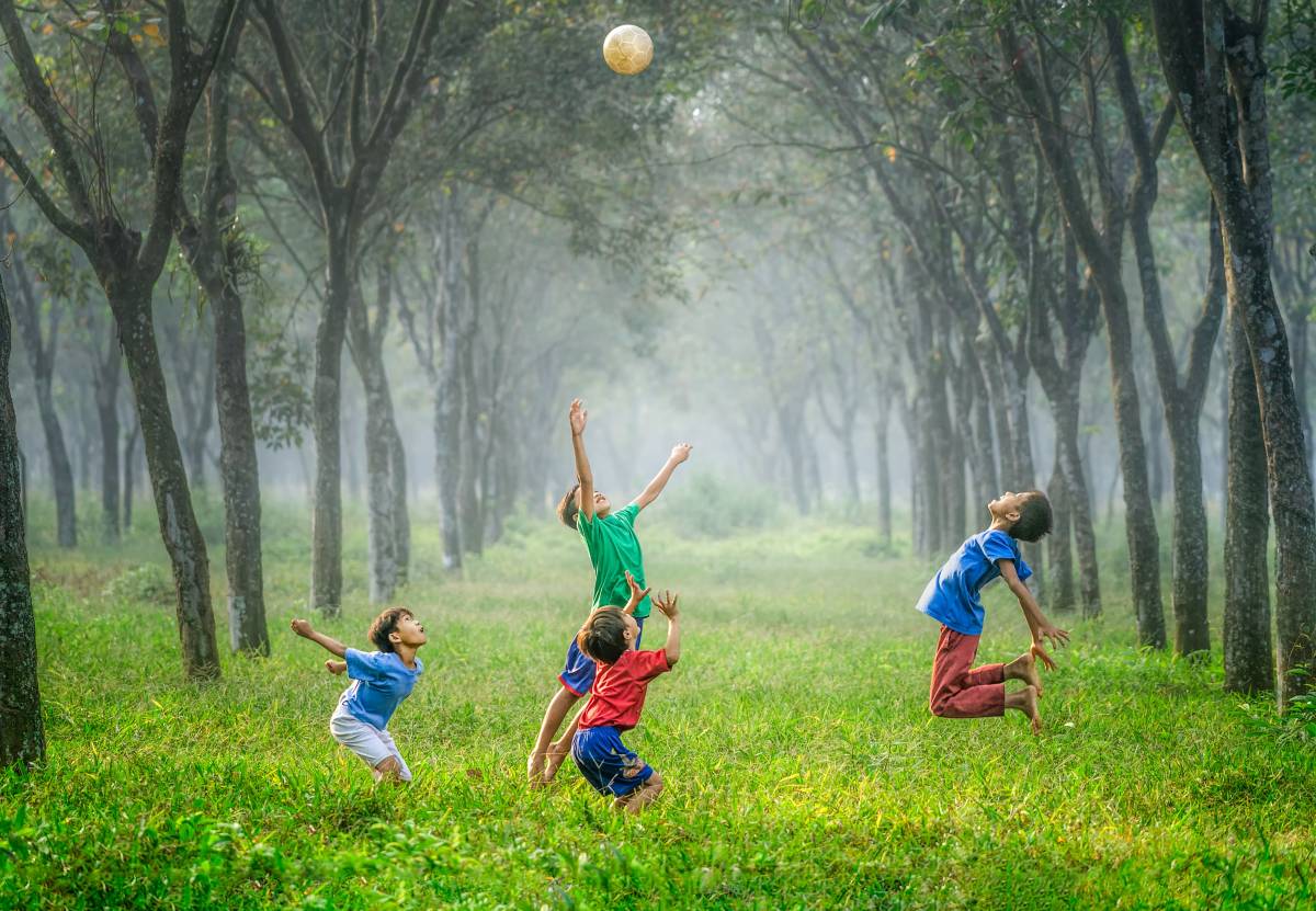 Children playing with the ball outside all together