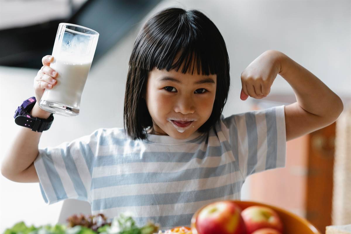 Girl drinking milk and doing a power pose
