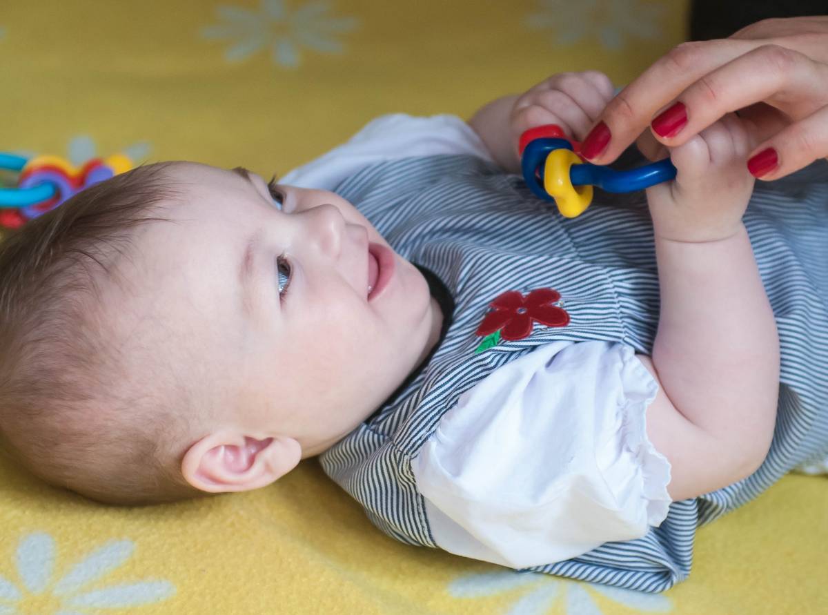 A baby holding a toy 