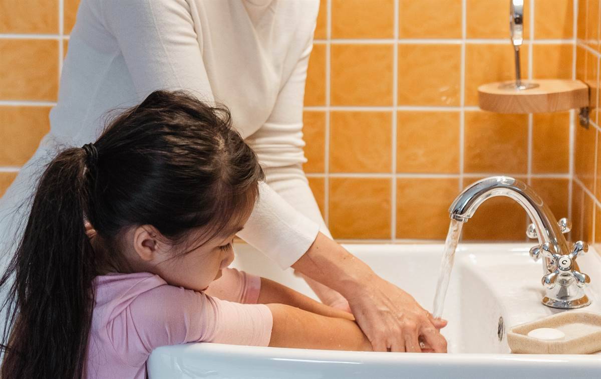 Child washing hands after the toilet 