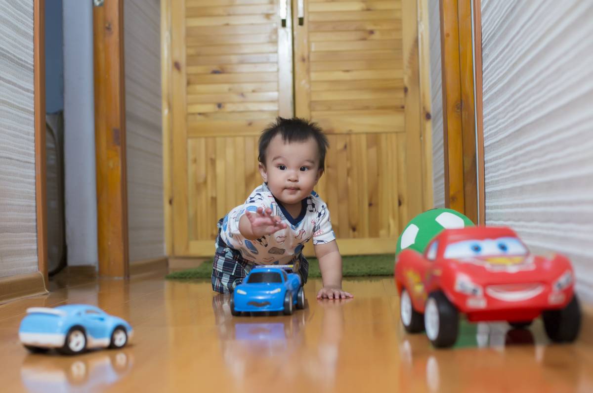 The boy is playing with cars