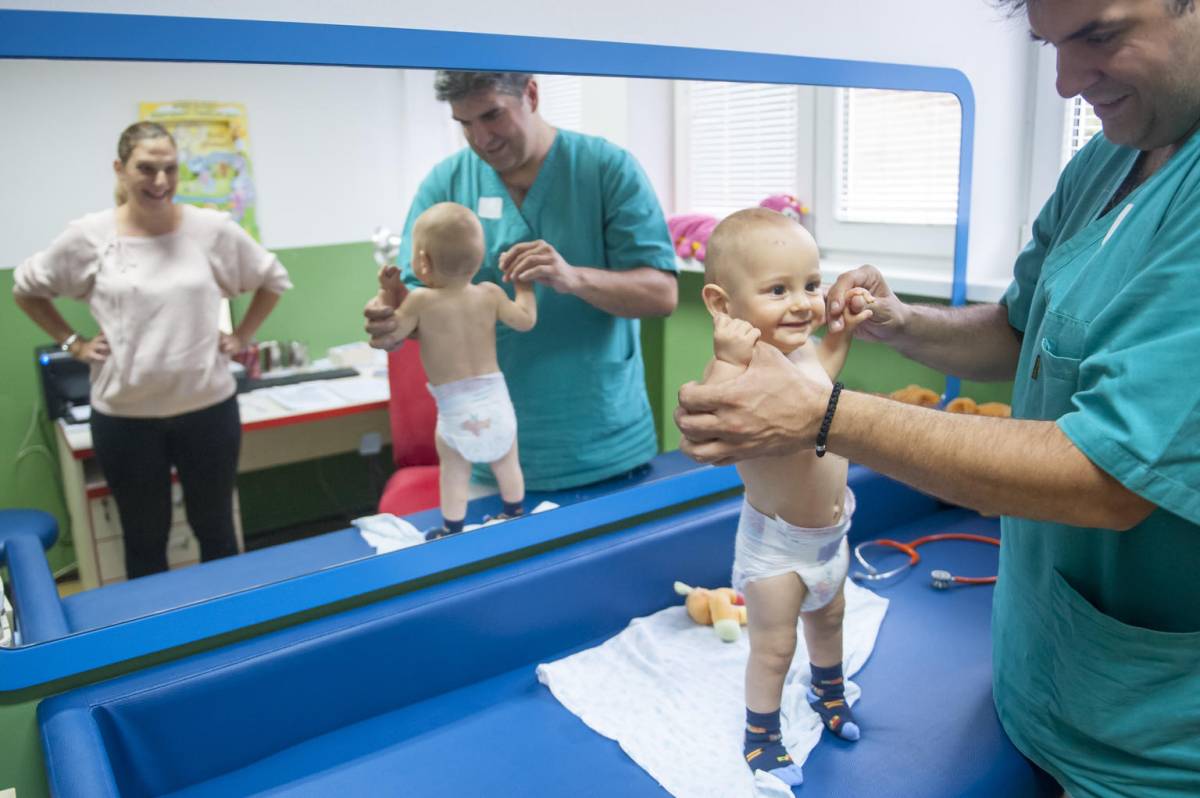 Doctor examining 6 month old boy