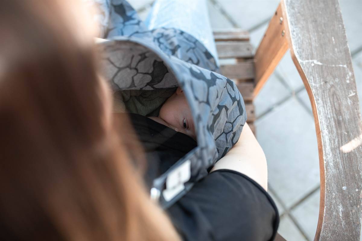 mother hiding breastfeeding behind a cloth