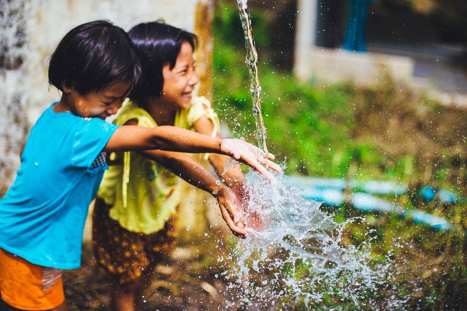 two children playing with water