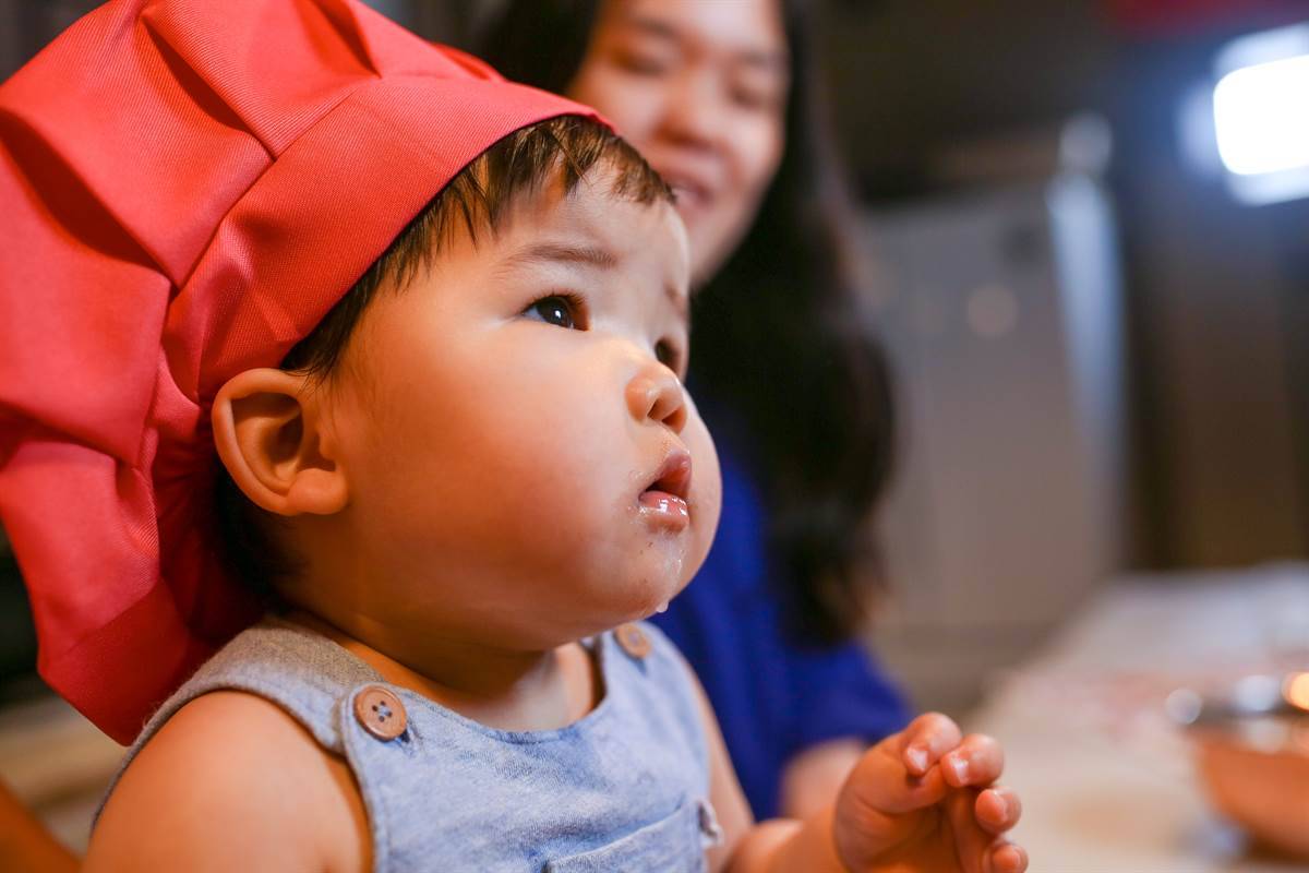 toddler with chef hat