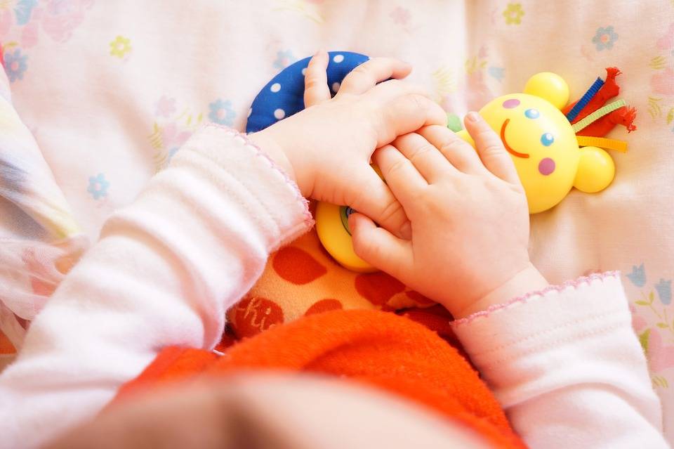 Baby holding a rattle