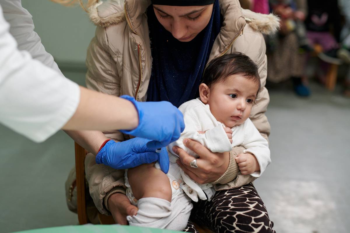 child receiving a DTP-IPV+Hib vaccine in group immunization session in Podgorica municipality, Montenegro