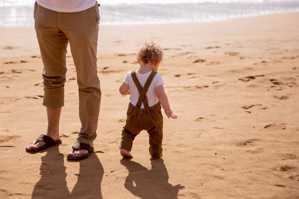 father and son enjoying the sun at the beach