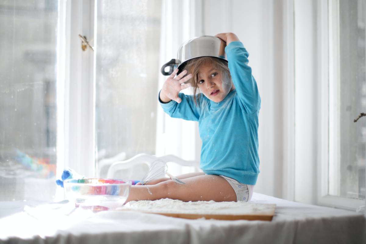 toddler wearing saucepan as a hat