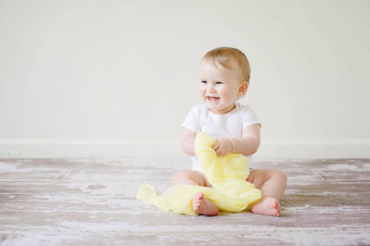 baby holding cotton cloth 