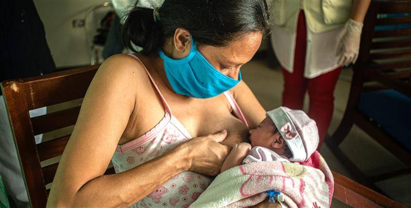 Woman breastfeeding infant