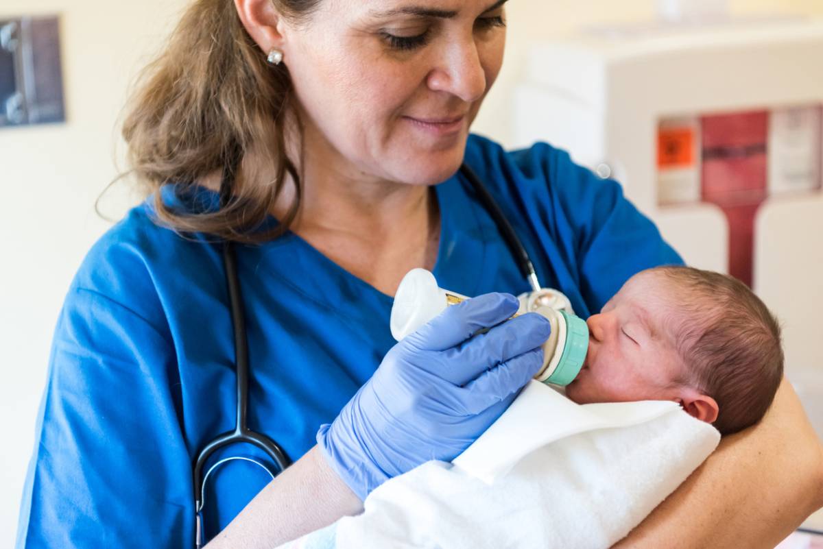 Nurse feeding baby
