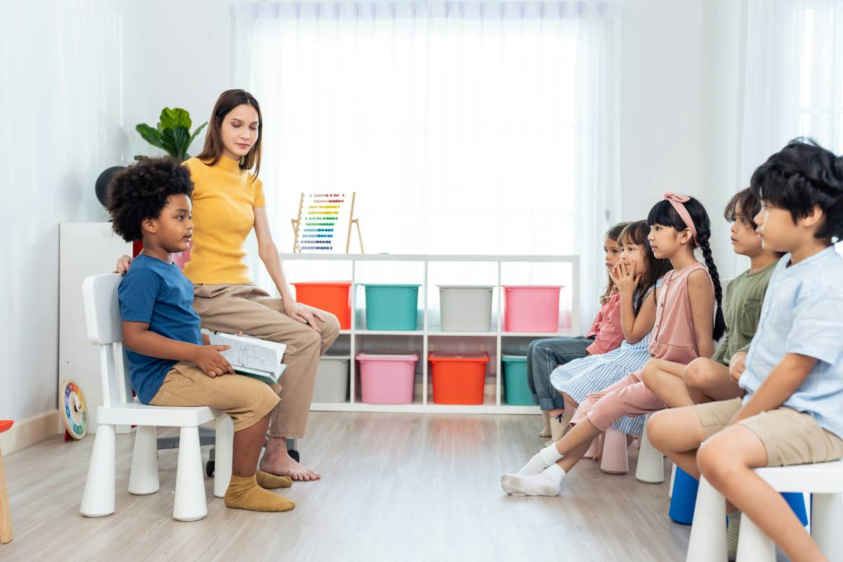 Young child reading to classmates