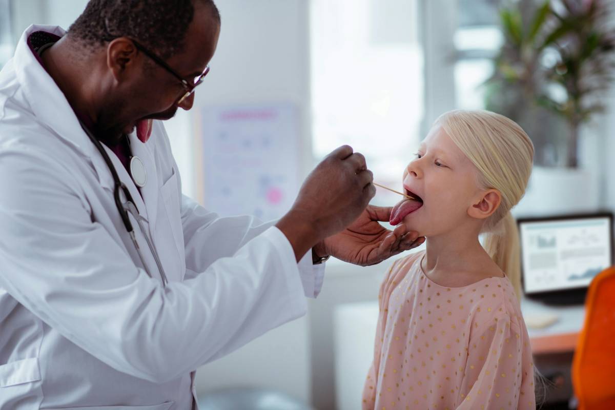Doctor checking child's mouth