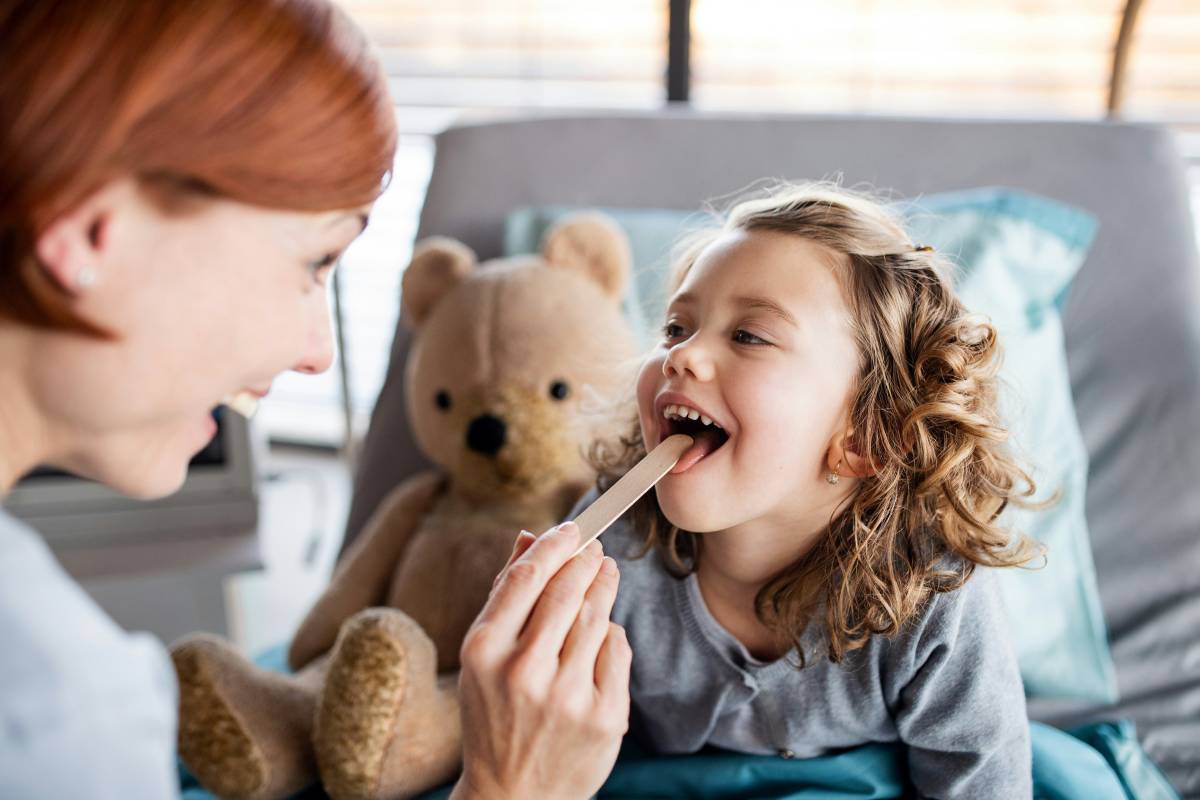 Doctor checking child's mouth