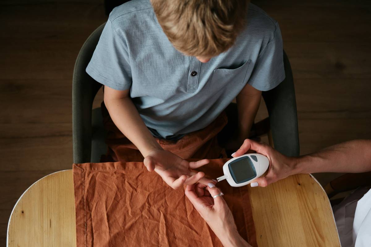 Boy testing blood sugar levels