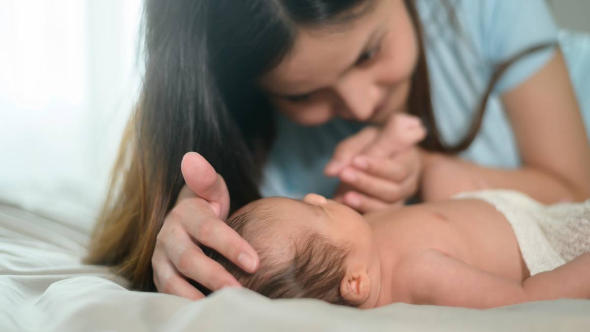 Mother interacting with her newborn baby