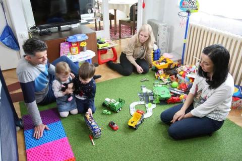Family playing with their children